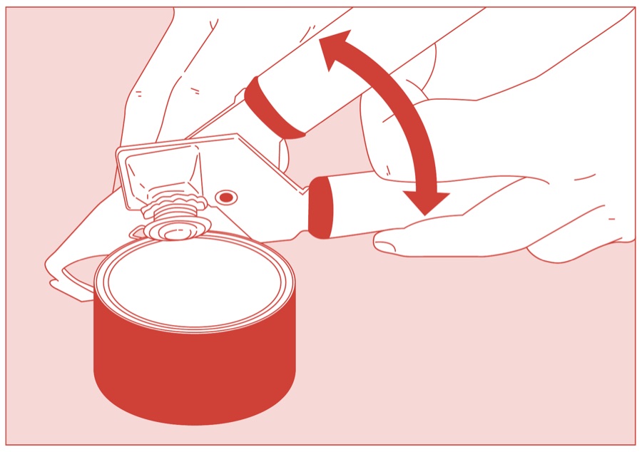 Hands opening the arms of a rotary can opener beside a tin of Red Feather butter
