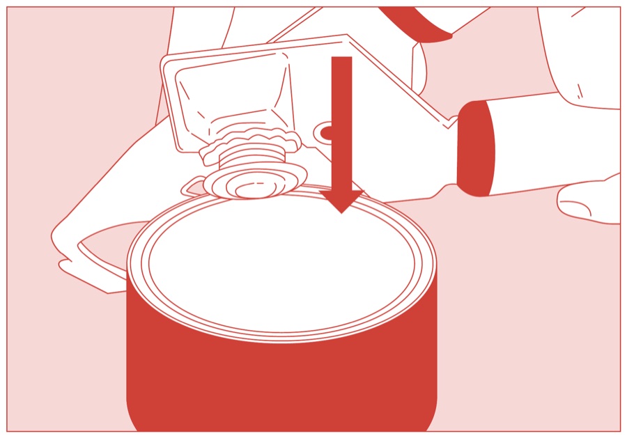 The can opener being lowered onto the lip of the tin lid