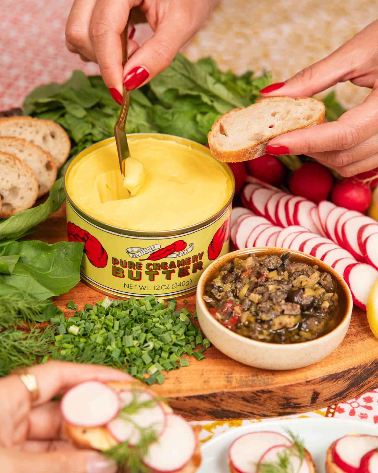 Red Feather butter spread onto bread at a shared table
