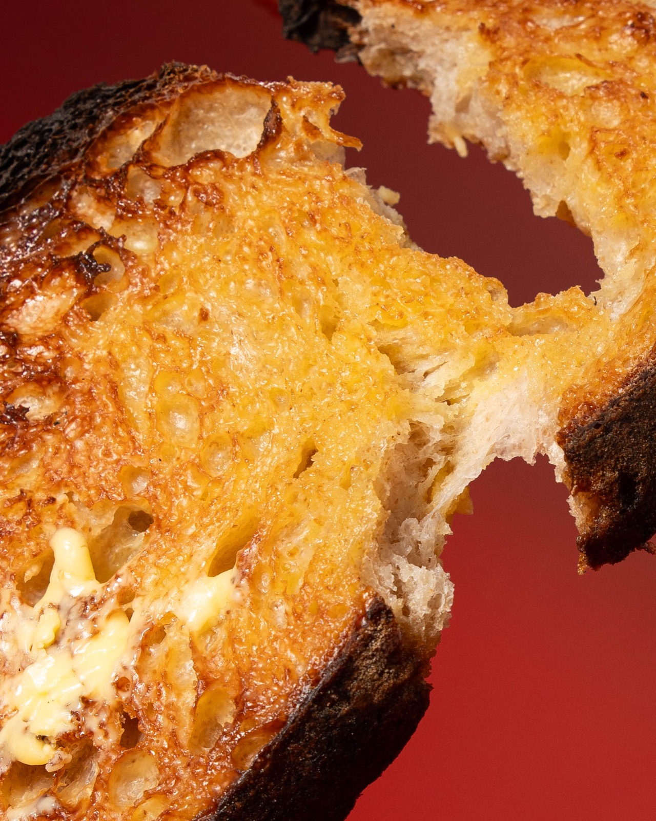 Melted butter soaking into a thick slice of toasted sourdough